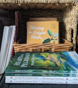 Poetry books in basket written by Jody Collins